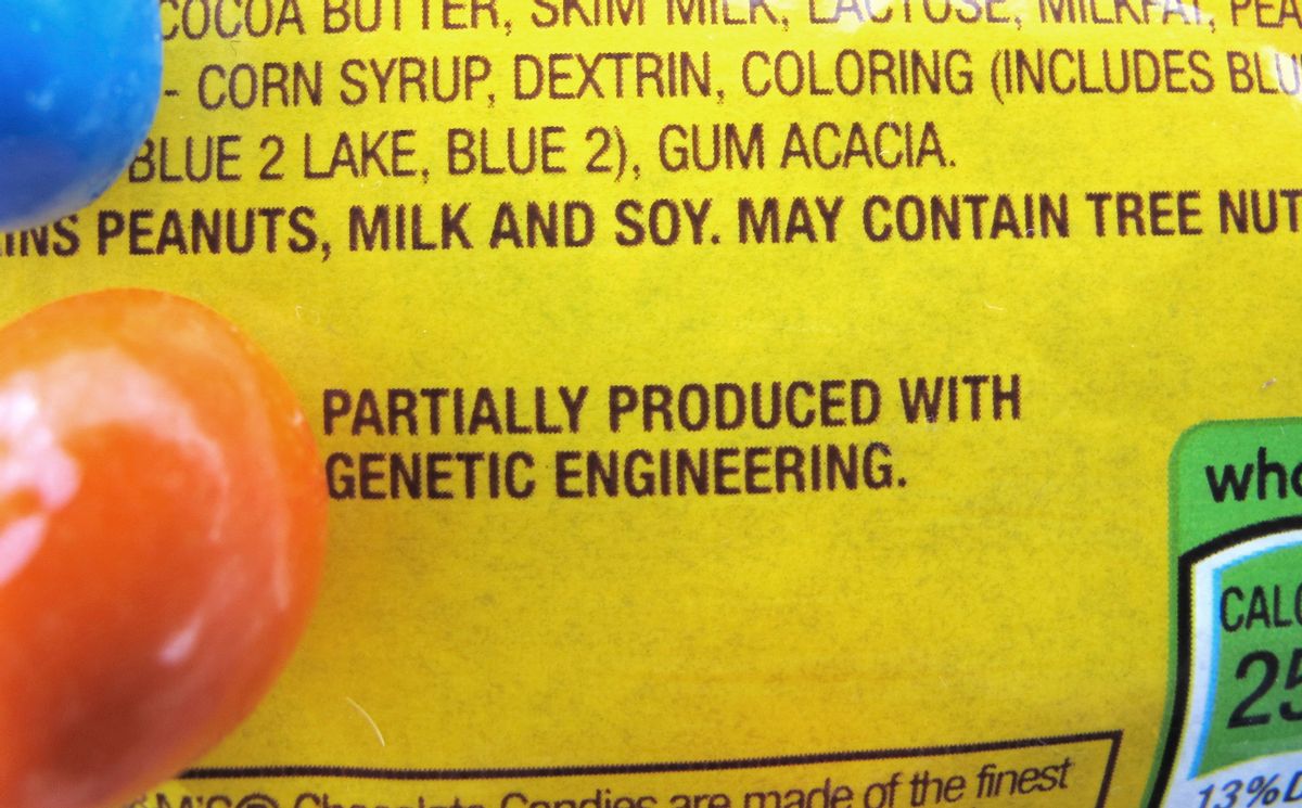 In this April 8, 2016 photo, a new disclosure statement is displayed on a package of Peanut M&amp;M�s candy in Montpelier, Vt., saying they are "Partially produced with genetic engineering."  (AP Photo/Lisa Rathke)