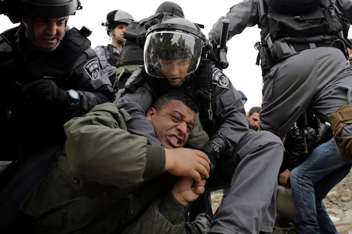 Israeli forces detain a Palestinian man at a protest in the occupied West Bank, near the town of Abu Dis on February 16, 2015  (Reuters/Ammar Awad)