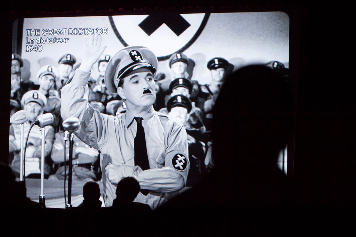 Spectators watch  the  movie  "The Great Dictator" with actor Charlie Chaplin  in the cinema   during the inauguration and the opening of the museum "Chaplin's World by Grevin" at the Manoir de Ban, in Corsier-Sur- Vevey, Switzerland, Saturday, April 16, 2016.   (Laurent Gillieron/Keystone via AP)