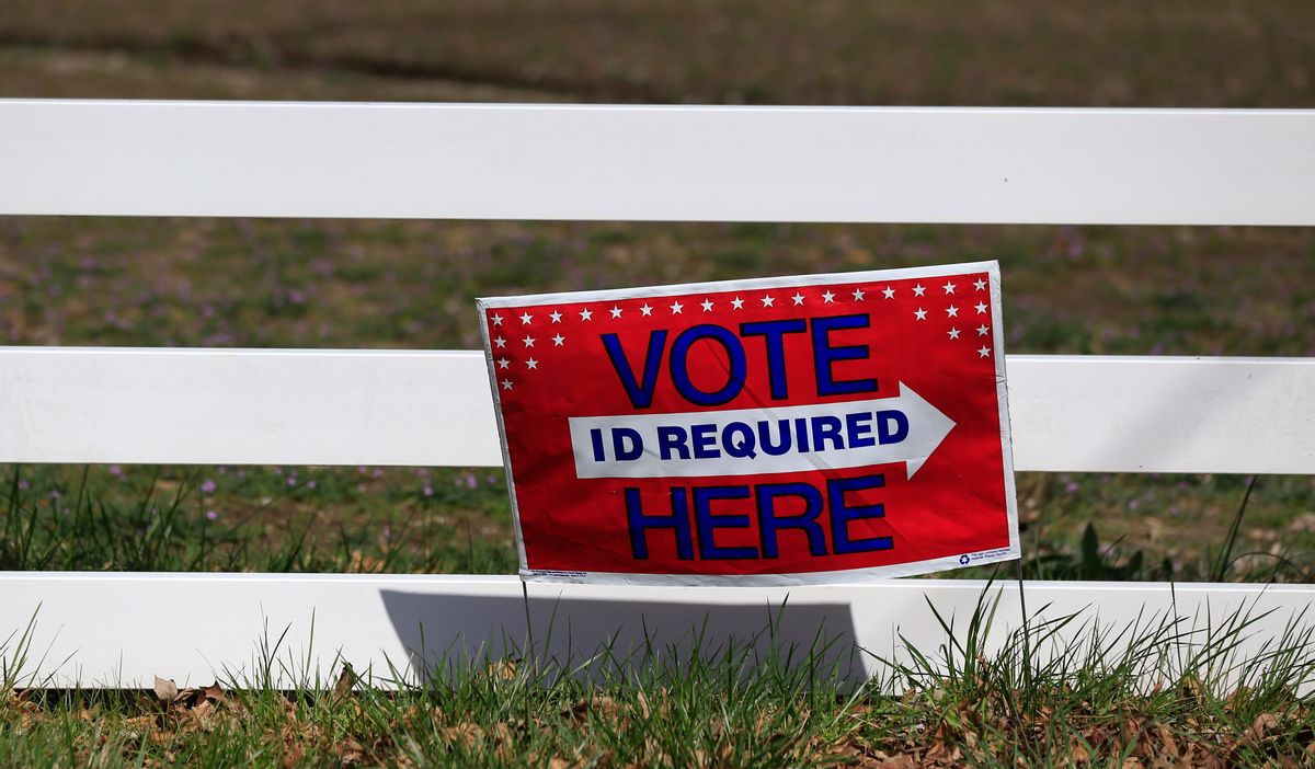 A sign directing voters is posted along a fence line at the Platte County Fair Grounds in Tracy, Mo. (AP)