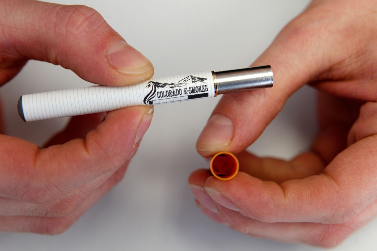 FILE - In this March 2, 2011, file photo, a clerk holds an electronic cigarette and the filter end that holds the liquid nicotine solution at an E-Smokes store in Aurora, Colo. Increasingly popular e-cigarettes and cigar varieties could be exempt from some government safety regulations if House Republicans have their way. It's a move that alarms Democrats and public health advocates who argue that it could lead to unsafe products. (AP Photo/Ed Andrieski, File) (AP)