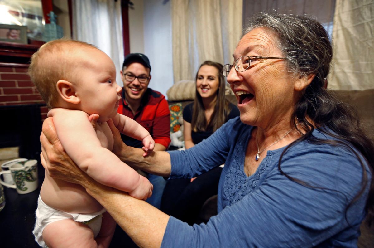 In this Friday, May 27, 2016 photo, Jill Breen, a midwife, examines 10-week-old Maggie Dickson while her parents Jamie and Shannon Dickson look on, at their home in Waterville, Maine. (AP Photo/Robert F. Bukaty) (AP)