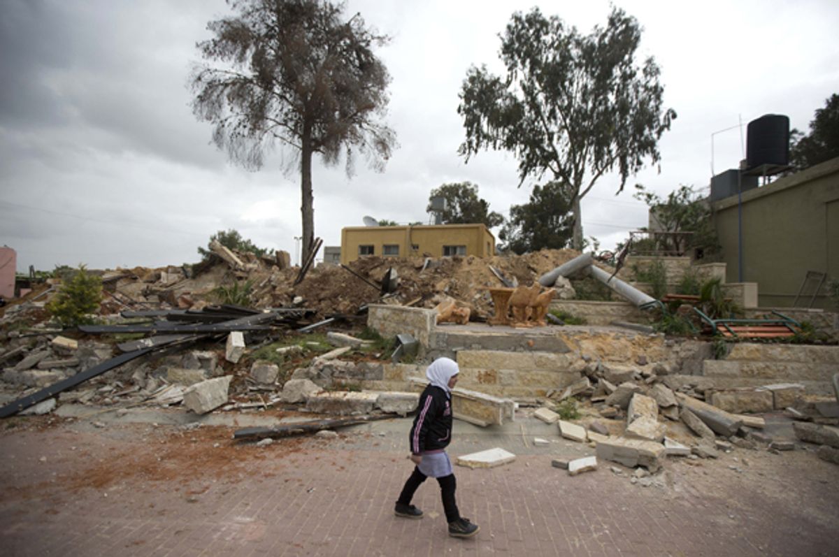 A Palestinian girl passes the ruins of a children's garden after it was demolished by Israeli troops in the village of Za'tara near the West Bank city of Nablus, April 12, 2016.   (AP/Majdi Mohammed)