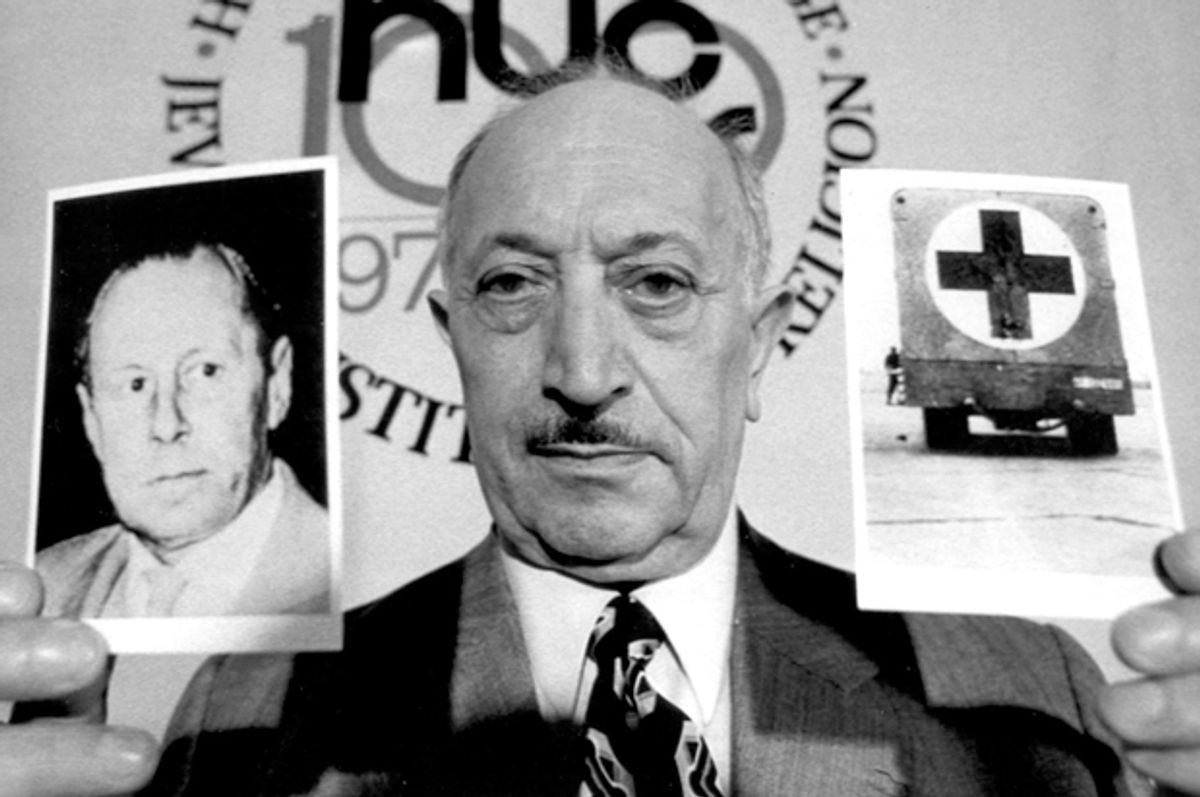 Simon Wiesenthal displays two pictures,  which he says refer to Nazi criminal Walter Rauff, May 31, 1973.   (AP)