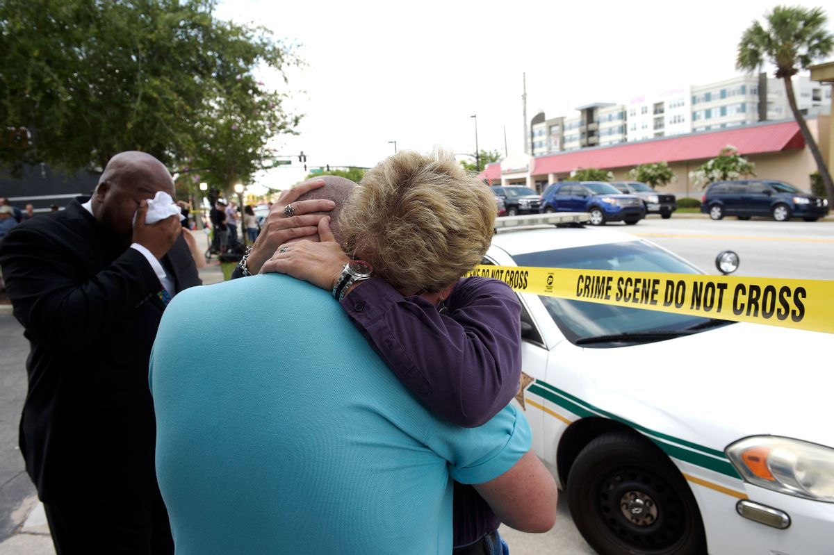 Terry DeCarlo, executive director of the LGBT Center of Central Florida, center, is comforted by Orlando City Commissioner Patty Sheehan. (AP/Phelan M. Ebenhack)