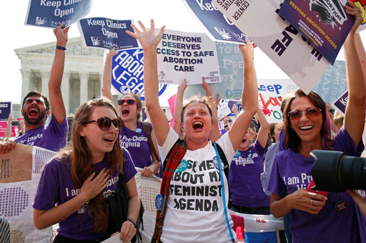 Demonstrators celebrate at the U.S. Supreme Court after it struck down a Texas law imposing strict regulations on abortion doctors and facilities, June 27, 2016.   (Reuters/Kevin Lamarque)
