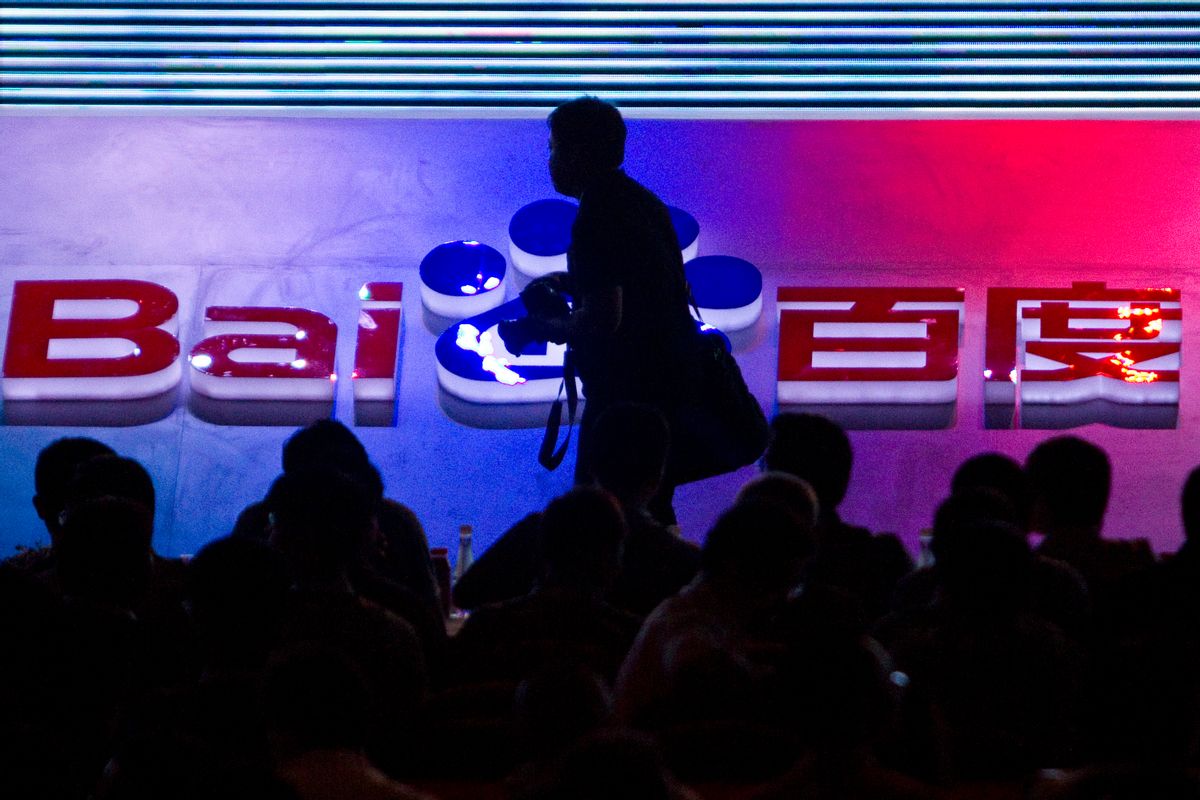 FILE - In this Sept. 2, 2011 file photo, a photographer walks past the logo of Baidu Inc., which operates China's dominant search engine, during a technology innovation conference held by the company at China's National Convention Center in Beijing, China.  (AP Photo/Alexander F. Yuan, File) (AP)