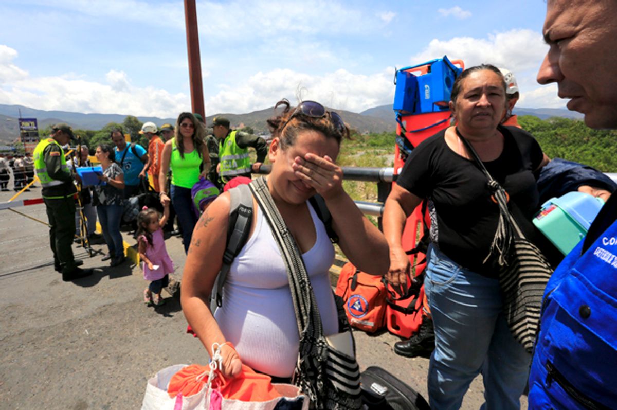 A Colombian woman cries after being deported from Venezuela, as she arrives with her family at the Simon Bolivar bridge border, near Villa del Rosario village, Colombia, August 25, 2015.   (Reuters/Jose Miguel Gomez)