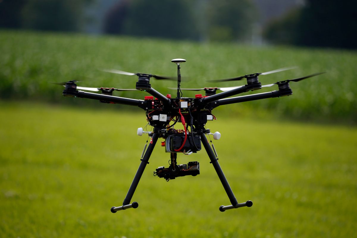 A hexacopter drone is flown during a drone demonstration at a farm and winery on potential use for board members of the National Corn Growers, Thursday, June 11, 2015 in Cordova, Md. Routine commercial use of small drones got a green light from the Obama administration June 21, 2016, after years of struggling to write regulations that would both protect public safety and unleash the economic potential and societal benefits of the new technology. (AP Photo/Alex Brandon) (AP)