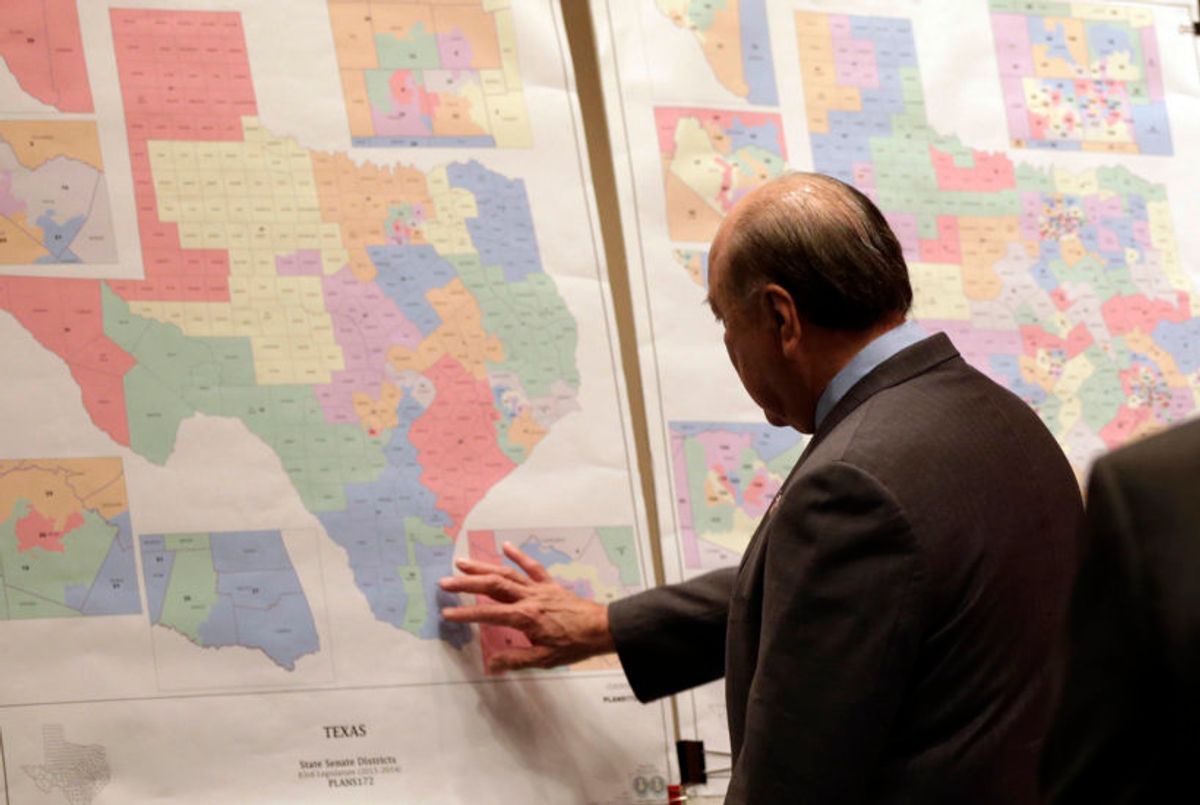 FILE - In this May 30, 2013 file photo, Texas state Sen. Juan "Chuy" Hinojosa looks at maps on display prior to a Senate Redistricting committee hearing in Austin, Texas.(AP Photo/Eric Gay, File) (AP/Eric Gay)