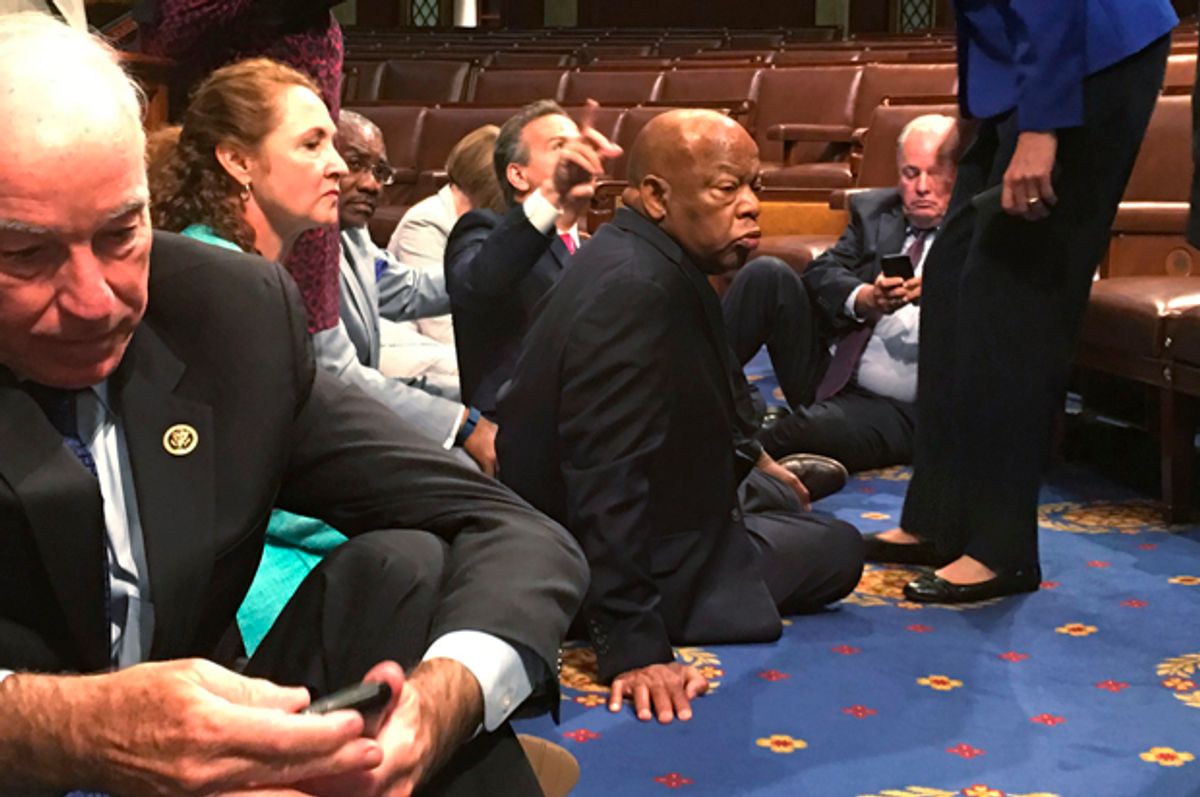 A photo shot and tweeted from the floor of the House by U.S. House Rep. John Yarmuth shows Democratic members of the House, including Joe Courtney (L) and John Lewis (C) staging a sit-in on the House floor "to demand action on common sense gun legislation," June 22, 2016.   (Reuters/U.S. Rep. John Yarmuth)