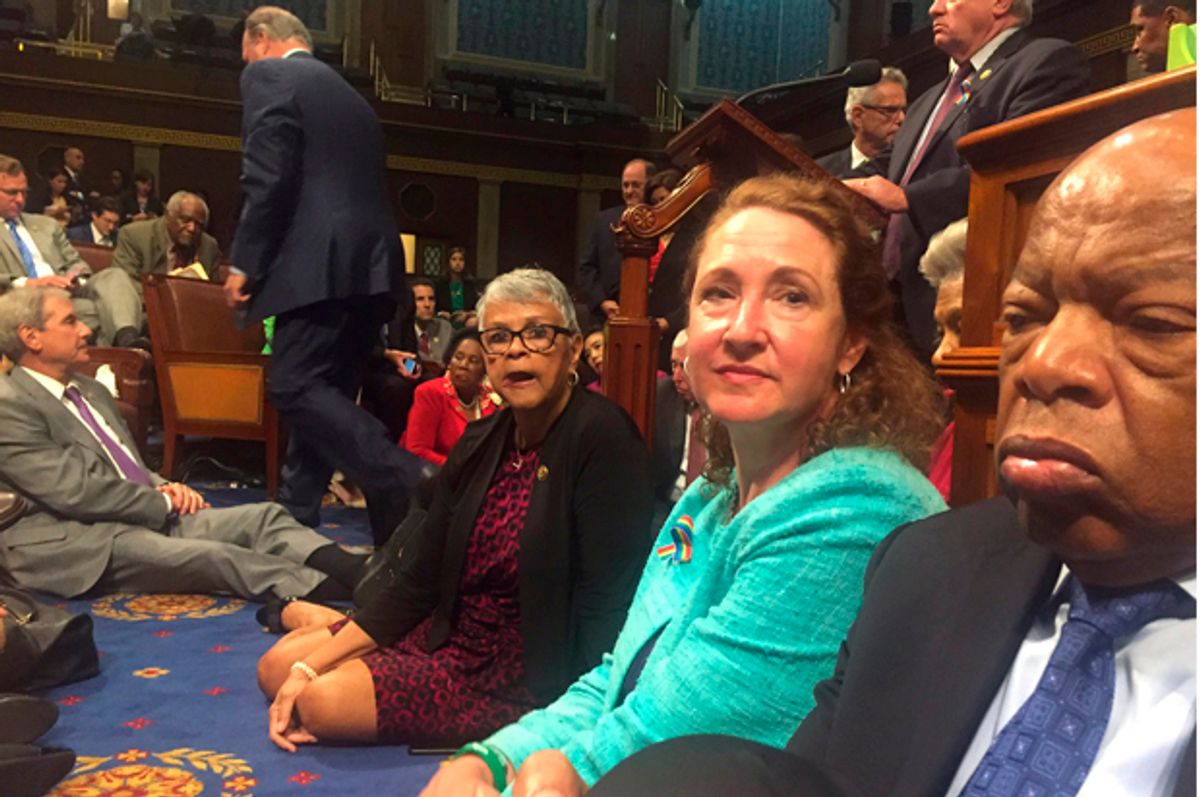A photo shot and tweeted from the floor of the House by U.S. House Rep. David Cicilline shows Democratic members of the U.S. House of Representatives staging a sit-in on the House floor "to demand action on common sense gun legislation," June 22, 2016.   (Reuters/U.S. Rep. David Cicilline)