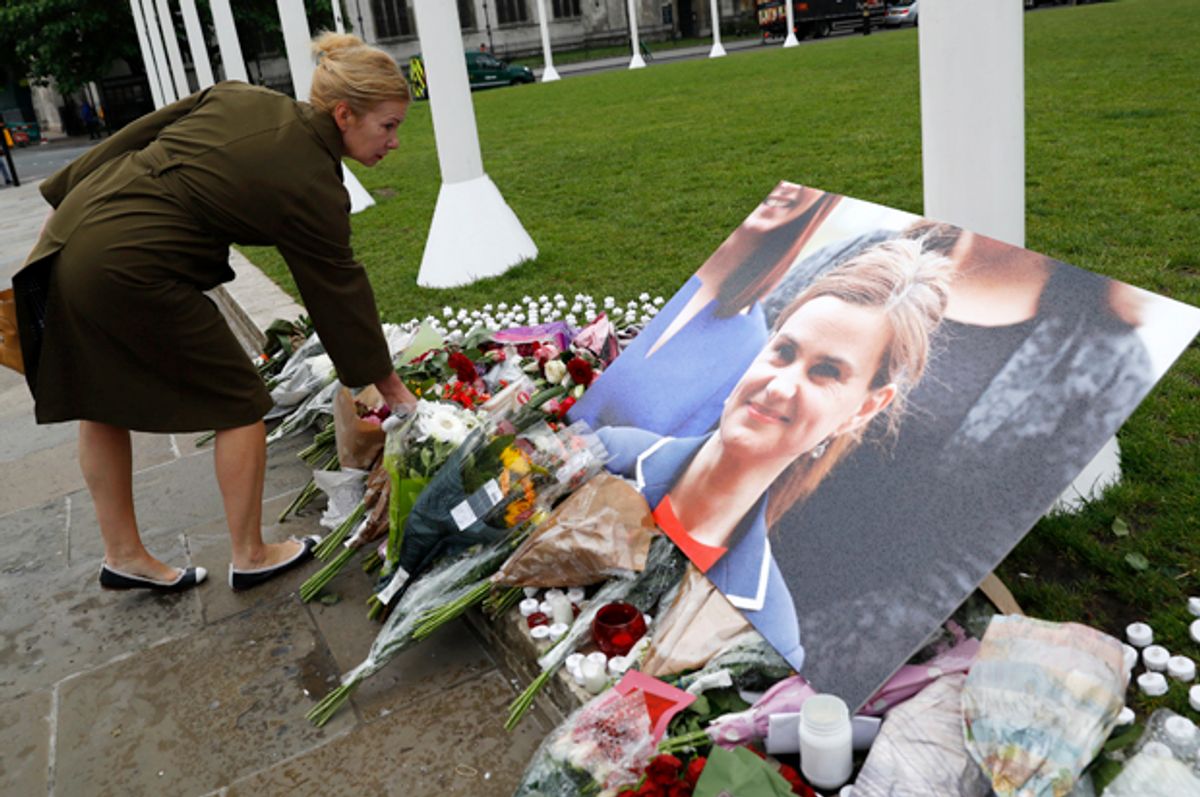 A woman leaves flowers at a memorial to Jo Cox in London, June 17, 2016.   (Reuters/Stefan Wermuth)