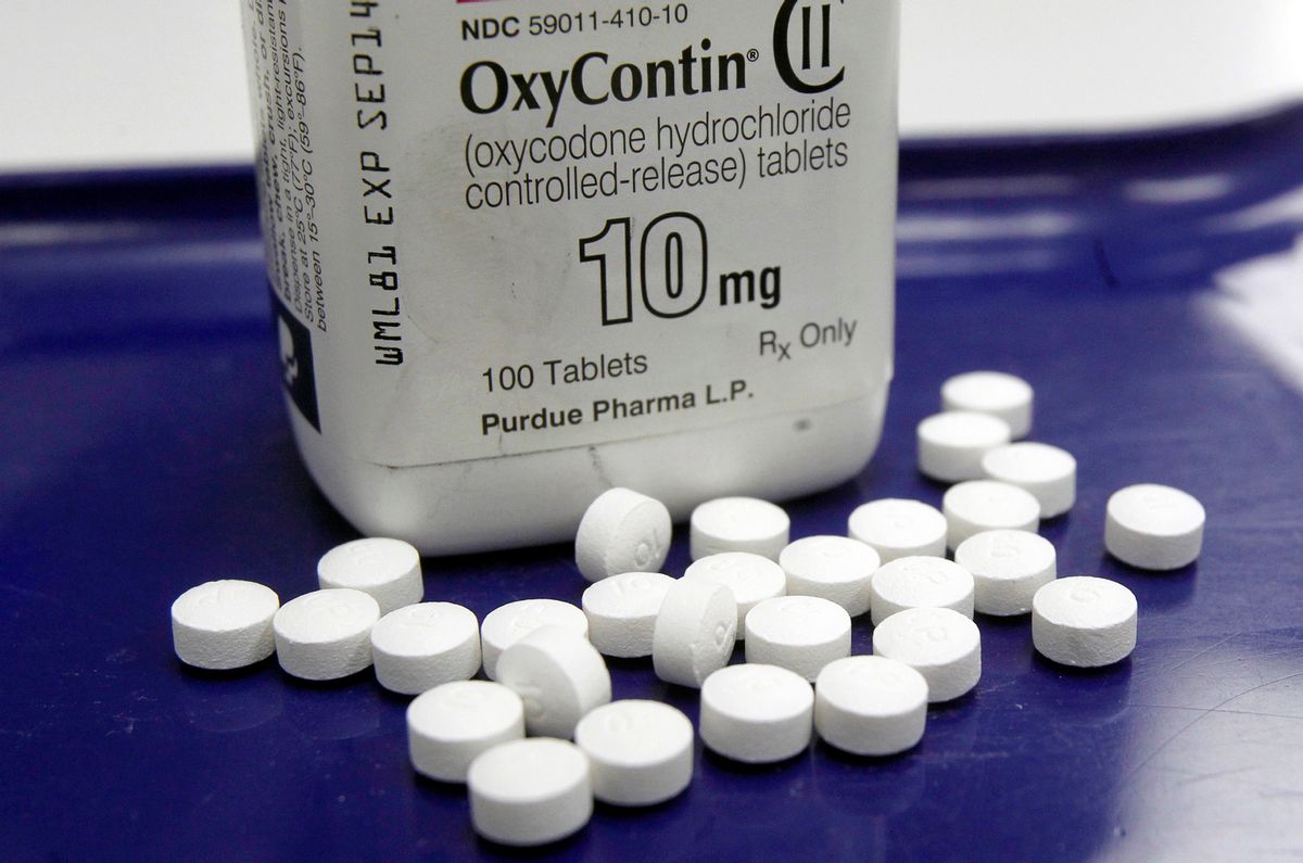 FILE - This Feb. 19, 2013, file photo, shows OxyContin pills arranged for a photo at a pharmacy in Montpelier, Vt. Overdoses don't happen just to heroin addicts _ patients who legally use strong painkillers called opioids are at risk in the nation’s epidemic, too. A new study says when patients were prescribed an overdose antidote along with those medications, they made fewer painkiller-related visits to the emergency room. The study released on June 27, 2016, went a step further _ to see if the take-home antidote idea also could work for patients with chronic pain who may not realize they could accidentally get into trouble with prescription painkillers such as Oxycontin, Vicodin and others. (AP Photo/Toby Talbot, File) (AP)