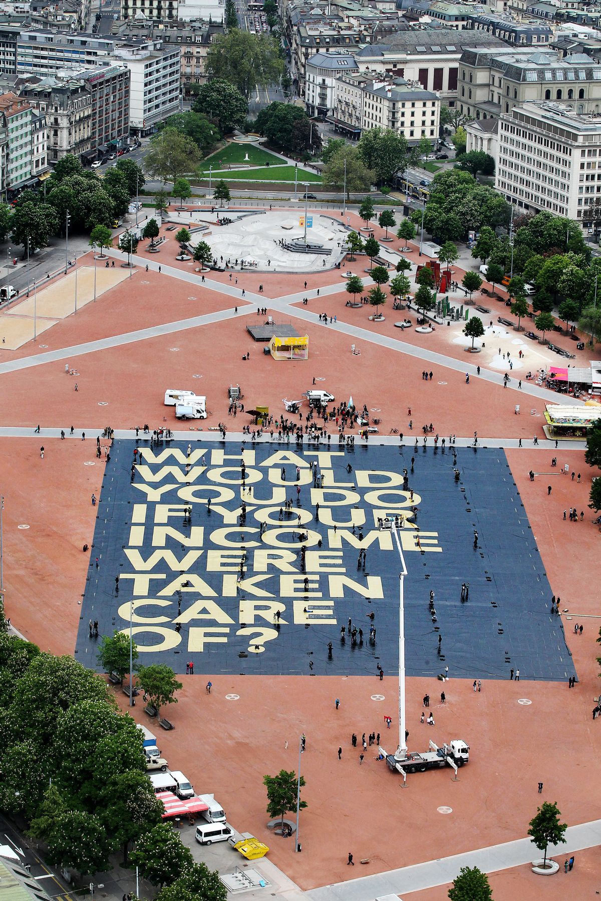 FILE -In this May 14, 2016 file picture, a huge poster reading What would you do if your income were taken care of? is pictured on the Plaine de Plainpalais square in Geneva, Switzerland.  The poster hints at a national referendum on June 5, were Swiss voters will have to decide on the introduction of an unconditional basic income for all.  ( Magali Girardin/Keystone via AP) (AP)