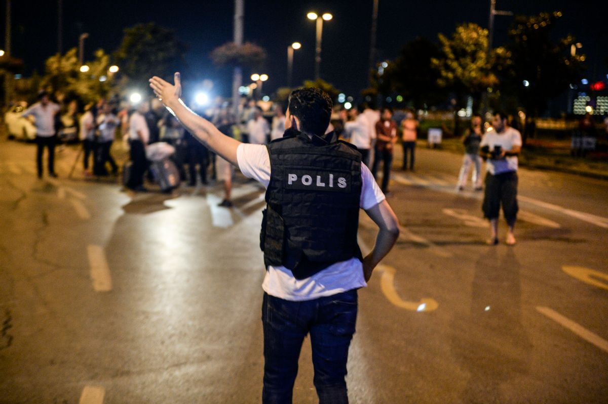 A police officer guides people outside Istanbul's Ataturk airport, Tuesday, June 28, 2016. Two explosions have rocked Istanbul's Ataturk airport, killing several people and wounding others, Turkey's justice minister and another official said Tuesday. A Turkish official says two attackers have blown themselves up at the airport after police fired at them. The official said the attackers detonated the explosives at the entrance of the international terminal before entering the x-ray security check. Turkish authorities have banned distribution of images relating to the Ataturk airport attack within Turkey. (AP Photo) TURKEY OUT (AP)