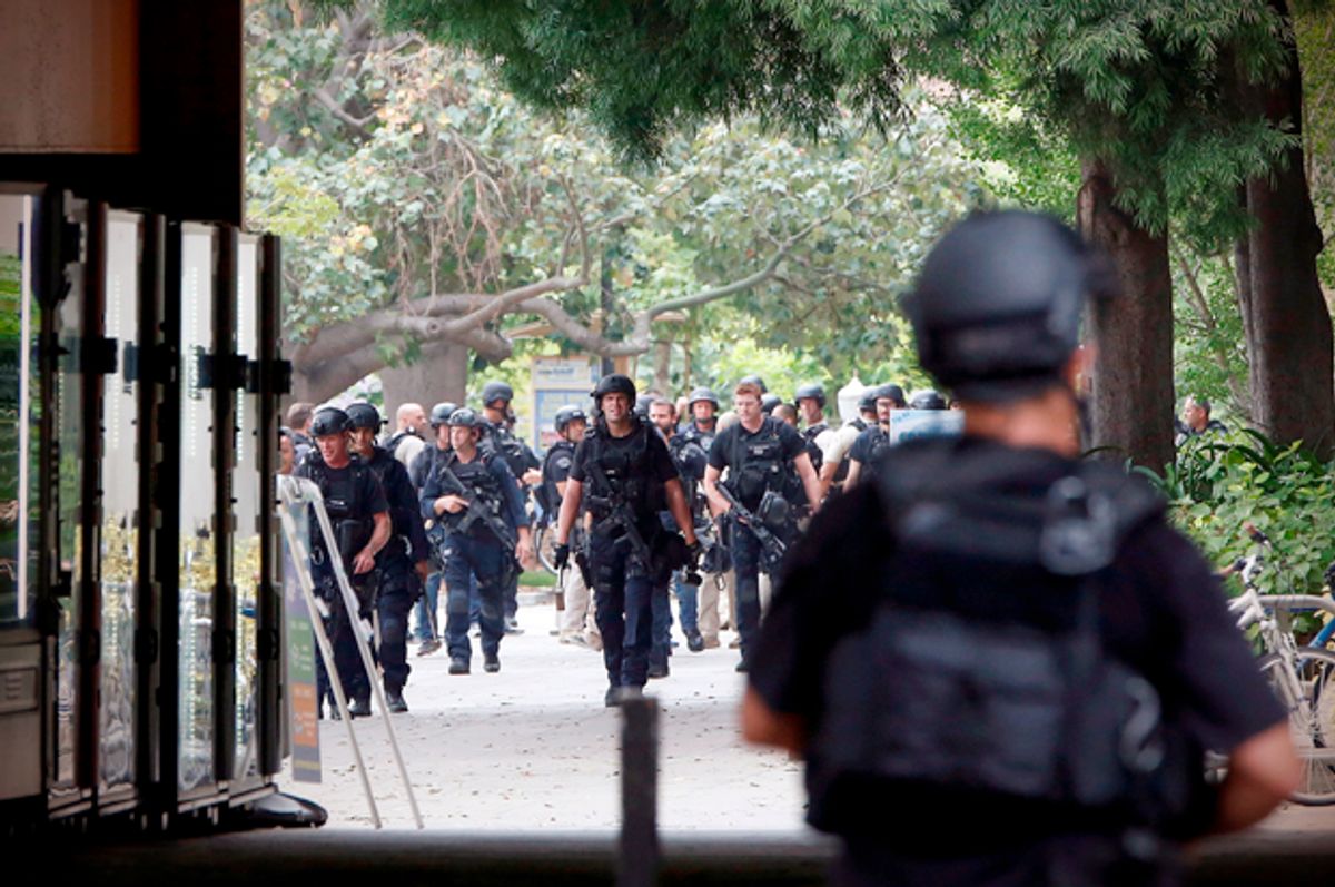 Police officers conduct a search at the University of California, Los Angeles (UCLA) campus after it was placed on lockdown following reports of a shooter that left 2 people dead in Los Angeles, California June 1, 2016.  REUTERS/Patrick T. Fallon - RTX2F8DZ (Reuters/Patrick T. Fallon)