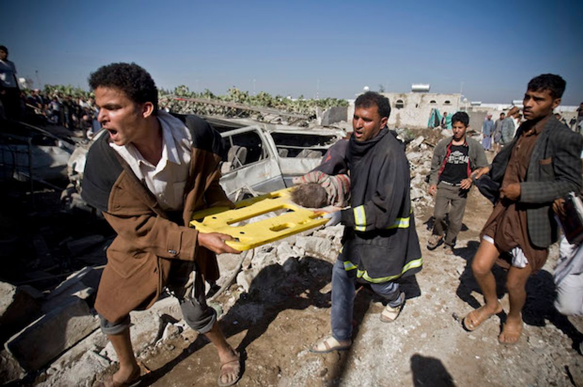 Yemenis carry the body of a child they uncovered from under the rubble of houses destroyed by Saudi airstrikes near Sana'a Airport, Yemen on March 26, 2015  (AP/Hani Mohammed)
