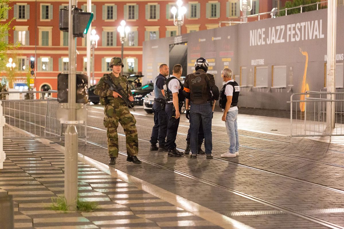 Police officers and a soldier stand by the sealed off area of an attack after a truck drove on to the sidewalk and plowed through a crowd of revelers who'd gathered to watch the fireworks in the French resort city of Nice, southern France, Friday, July 15, 2016. A spokesman for France's Interior Ministry says there are likely to be "several dozen dead" after a truck drove into a crowd of revelers celebrating Bastille Day in the French city of Nice. (AP Photo/Ciaran Fahey) (AP)