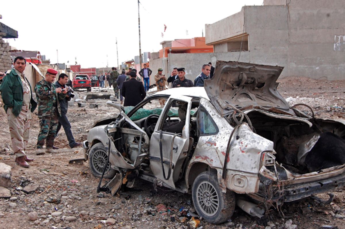 Iraqi security forces inspect the scene of a car bomb attack outside the northern city of Mosul, Iraq, Jan. 16, 2012.   (AP)