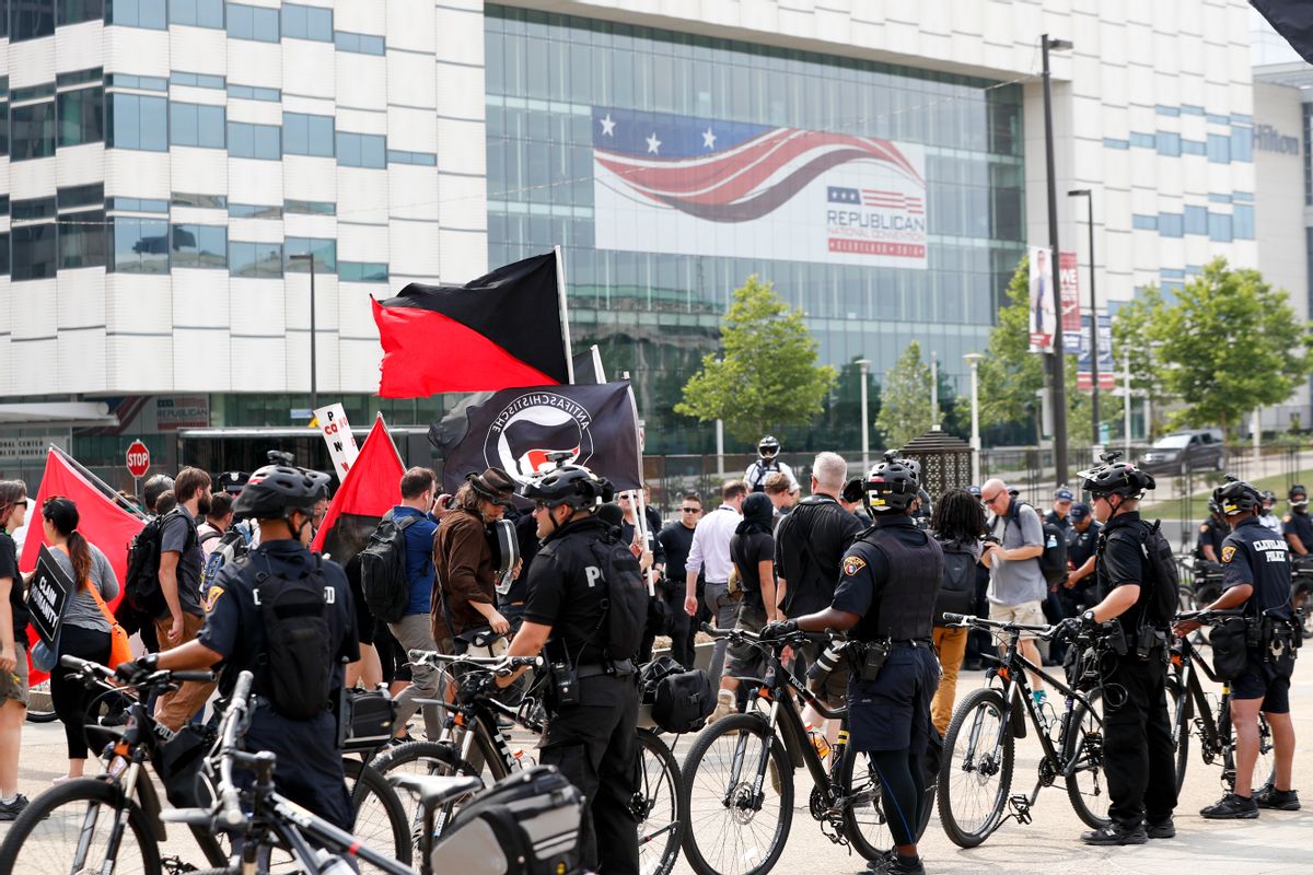 Protesters march as police look on near Public Square on Thursday, July 21, 2016, in Cleveland, during the final day of the Republican convention. (AP Photo/Alex Brandon) (AP)