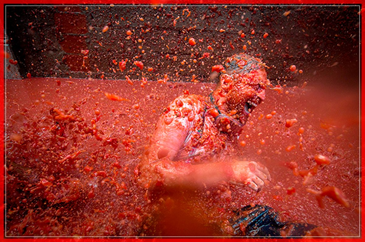 A reveller is pelted with tomato pulp during the annual "tomatina" festivities in the village of Bunol, near Valencia on August 31, 2016.  
Today at the annual Tomatina fiesta 160 tonnes of ripe tomatoes were offloaded from trucks into a crowd of 22,000 half-naked revellers who packed the streets of Bunol for an hour-long battle.



 / AFP / BIEL ALINO        (Photo credit should read BIEL ALINO/AFP/Getty Images) (Afp/getty Images)