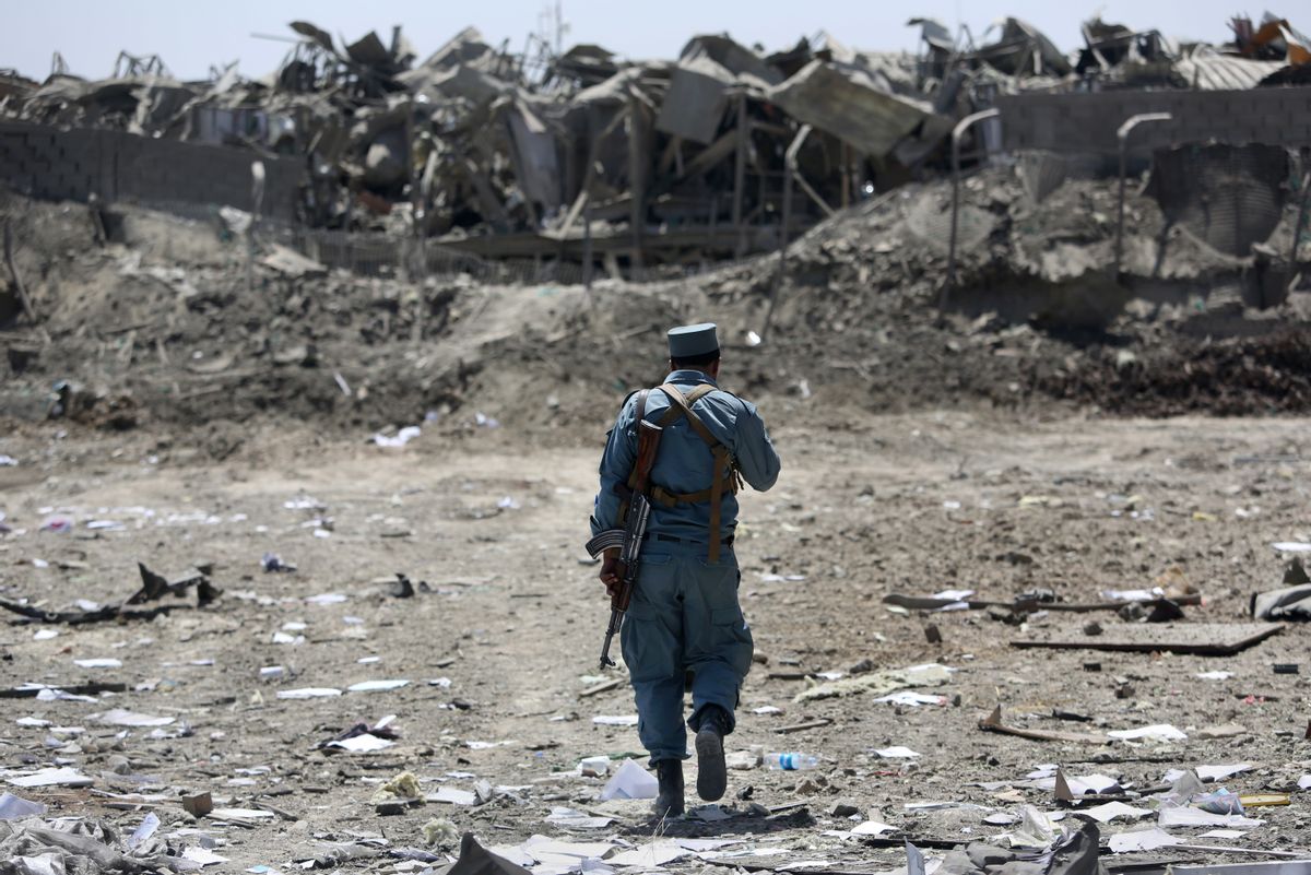 FILE - In this Monday, Aug. 1, 2016 file photo, an Afghan Security policeman inspects the site of a suicide truck bombing, in Kabul, Afghanistan.  (AP)