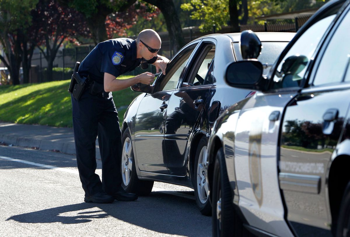 FILE - In this Nov. 12, 2012 file photo, A Sacramento Police Officer makes a traffic stop in Sacramento Calif. Young African-American adults say they are arrested and that they or someone they know has been harassed by police in far greater numbers than any other young Americans, despite the fact that a newly released poll shows they encounter police at just about the same rate as white, Hispanic and Asian adults their same age.  (AP Photo/Rich Pedroncelli, File) (AP)