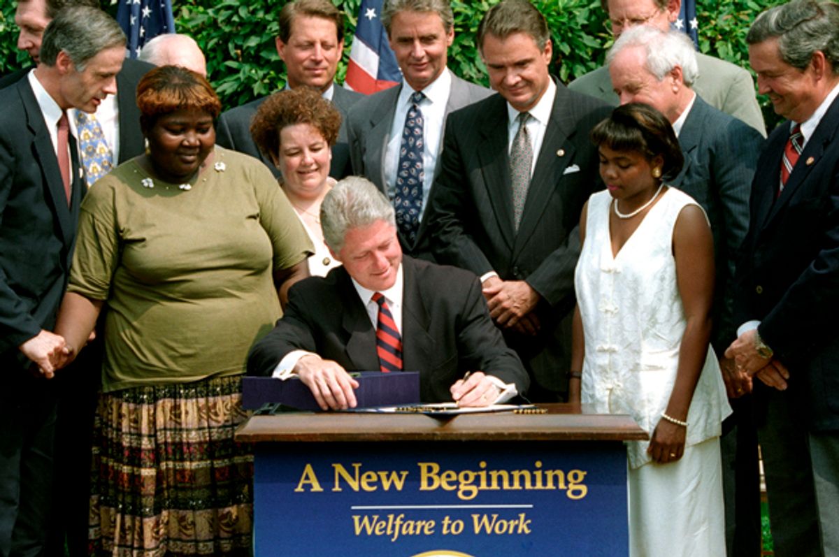 President Bill Cllinton signs the Personal Responsibility and Work Opportunity Act into law, August 22, 1996.    (Reuters/Stephen Jaffe)