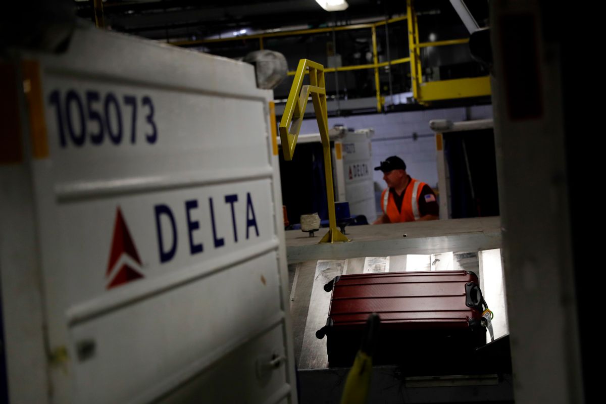 In this July 12, 2016, photo, a suitcase rides a carousel after being unloaded from a Delta Air Lines flight at Baltimore-Washington International Thurgood Marshall Airport in Linthicum, Md. Delta Air Lines is rolling out new technology to better track bags throughout its system. (AP Photo/Patrick Semansky) (AP)