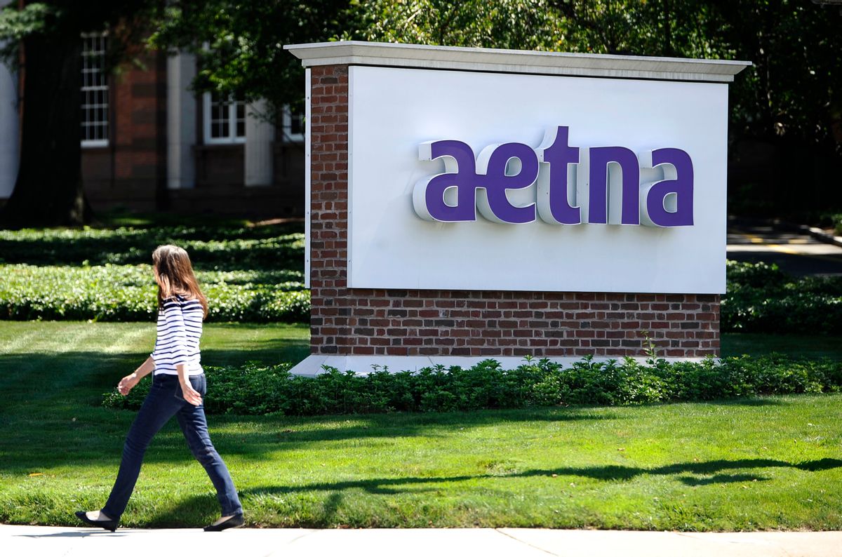 FILE - In this Tuesday, Aug. 19, 2014, file photo, a pedestrian walks past a sign for health insurer Aetna Inc., at the company headquarters in Hartford, Conn. Aetna Inc. reports financial results Tuesday, Aug. 2, 2016. (AP Photo/Jessica Hill, File) (AP)