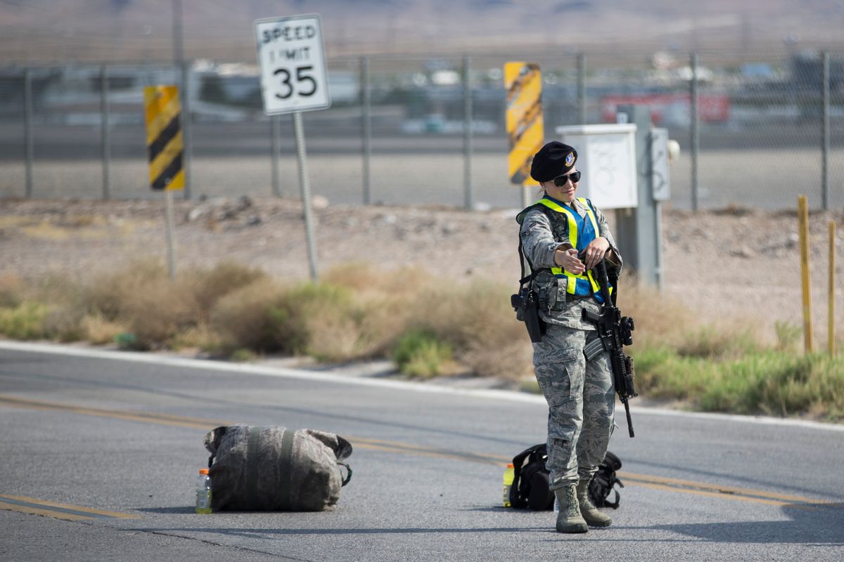 Nellis Air Force Base military police block the road at the intersection of North Las Vegas Boulevard and North Hollywood Boulevard after an aircraft crash near the area on Thursday, Aug. 18, 2016, in Las Vegas. An official says a veteran pilot had just completed an exercise with a military weapons school at an Air Force base near Las Vegas when he ejected as the plane went down. (Erik Verduzco/Las Vegas Review-Journal via AP) (AP)