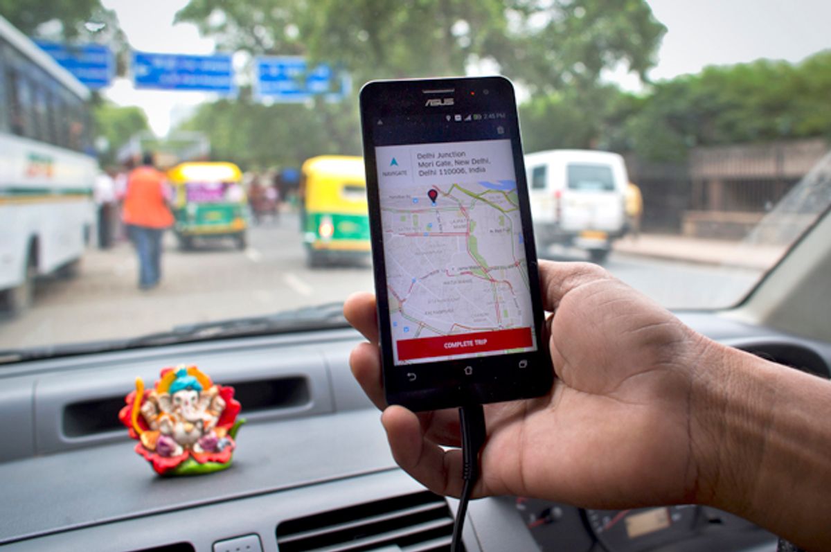 An Indian cab driver displays the city map on a smartphone provided by Uber as he drives in New Delhi, July 31, 2015.   (AP/Saurabh Das)
