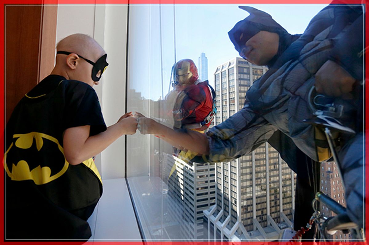 Gesus Lamadrid, right, dressed up as Batman and Orlando Gonzales, center dressed up as Iron Man interact with 8-year-old Tyler Levin Monday, Sept. 19, 2016, in Chicago. A window washing crew dressed up as superheroes to entertain the young patients at the hospital. (AP Photo/Tae-Gyun Kim) (AP)