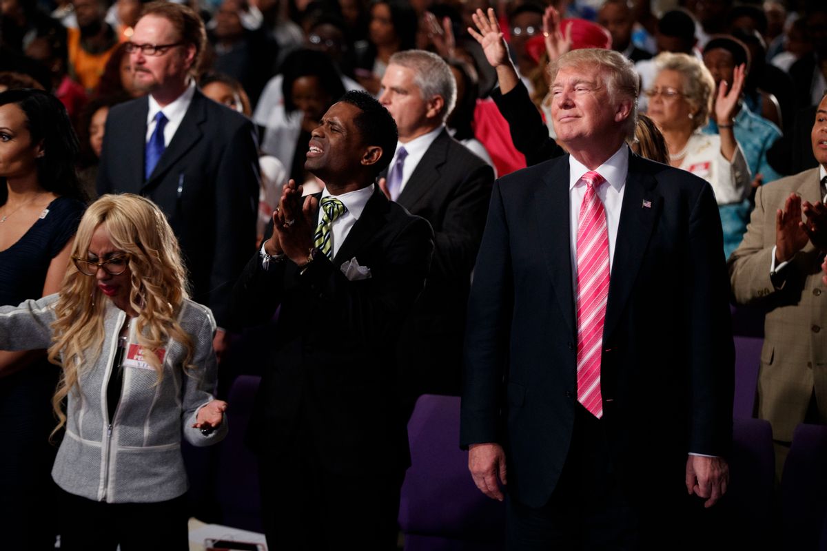 Donald Trump, right, stands and listens during a church service at Great Faith Ministries, Saturday, Sept. 3, 2016, in Detroit. (AP Photo/Evan Vucci) (AP)