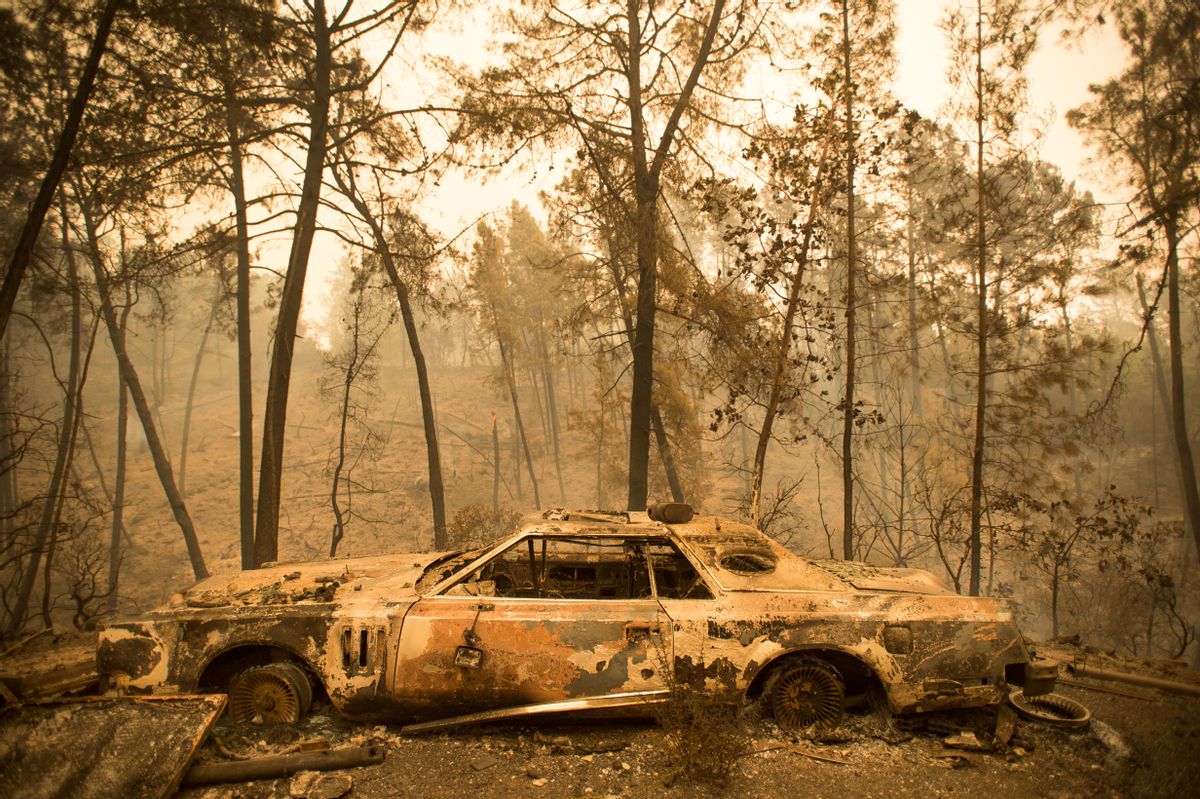 A vintage car rests in a driveway after the Loma fire burned through Loma Chiquita Road near Morgan Hill, Calif., on Wednesday, Sept. 28, 2016.  A heat wave stifling drought-stricken California has worsened a wildfire that burned some buildings and forced people from their homes.   (AP Photo/Noah Berger) (AP)