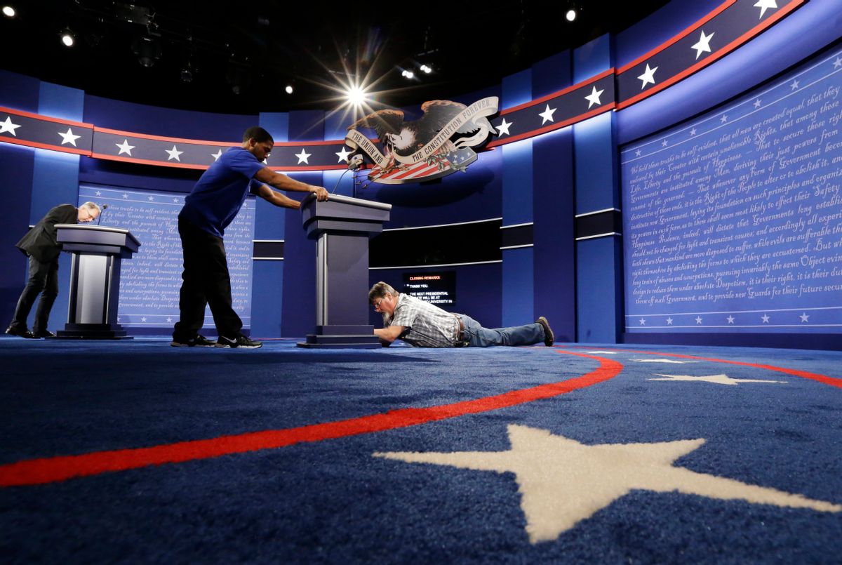 Technicians set up the stage for the presidential debate between Democratic presidential candidate Hillary Clinton and Republican presidential candidate Donald Trump at Hofstra University in Hempstead, N.Y., Sunday, Sept. 25, 2016.  (AP)