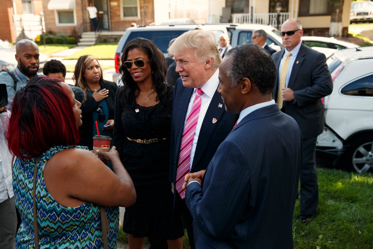 Neighborhood resident Felicia Reese, left, talks with Republican presidential candidate Donald Trump and Dr. Ben Carson, during a tour of Carson's childhood home, Saturday, Sept. 3, 2016, in Detroit. (AP)