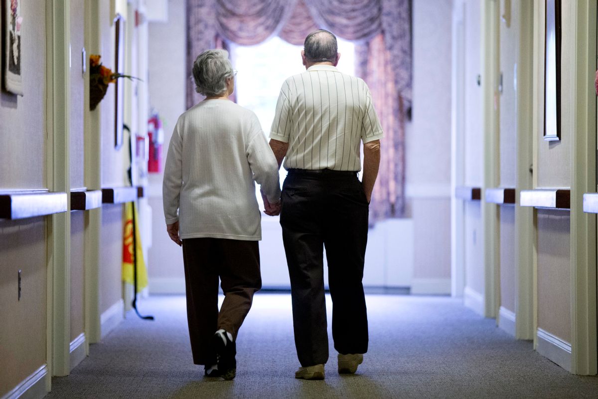 FILE - In this Nov. 6, 2015 file photo, an elderly couple walks down a hall in Easton, Pa. It's not too late to get moving: Simple physical activity, mostly walking, helped high-risk seniors stay mobile after disability-inducing ailments even if, at 70 and beyond, they'd long been couch potatoes.  (AP Photo/Matt Rourke, File) (AP)
