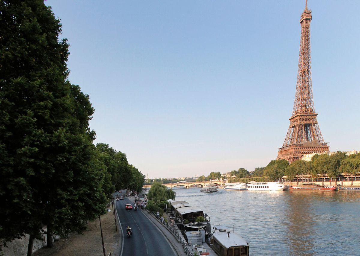 FILE - In this July 21, 2013 file photo shows the road along the Seine river, with the Eiffel Tower at right, in Paris. Paris City Hall has approved Monday Sept.26, 2016 a controversial plan to close down a stretch of highway that runs along the Seine River through central Paris and transform it into a pedestrian zone. It's part of Mayor Anne Hidalgo's push to fight Paris' exceptionally high pollution. (AP Photo/Christophe Ena, File) (AP)