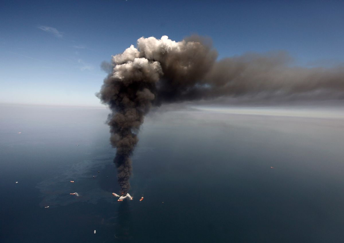 This April 21, 2010, file photo shows a large plume of smoke rising from BP's Deepwater Horizon offshore oil rig in the Gulf of Mexico. (AP Photo/Gerald Herbert, File)