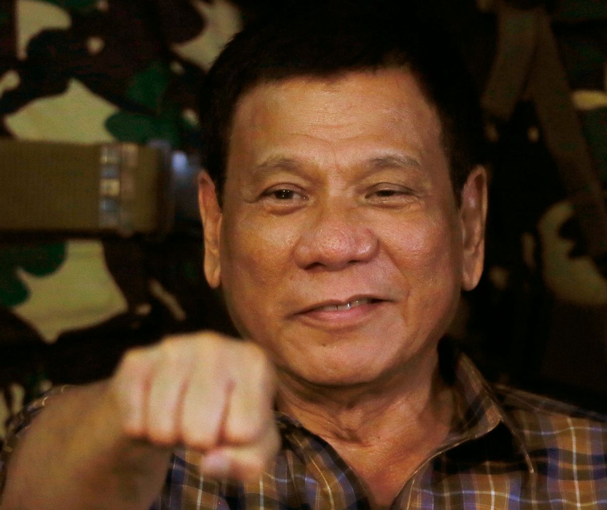 FILE - In this Aug. 25, 2016, file photo, Philippine President Rodrigo Duterte gestures with a fist bump during his visit to the Philippine Army's Camp Mateo Capinpin at Tanay township, Rizal province east of Manila, Philippines. Duterte raised his bloody anti-crime war rhetoric to a new level Friday, Sept. 30, 2016, comparing it to how Hitler massacred millions of Jews and saying how he would be "happy to slaughter" 3 million addicts. Duterte issued his latest threat against drug dealers and users early Friday on returning to his home in southern Davao city after visiting Vietnam, where he discussed his anti-drug campaign with Vietnamese leaders and compared notes on battling the problem. (AP Photo/Bullit Marquez, File) (AP)