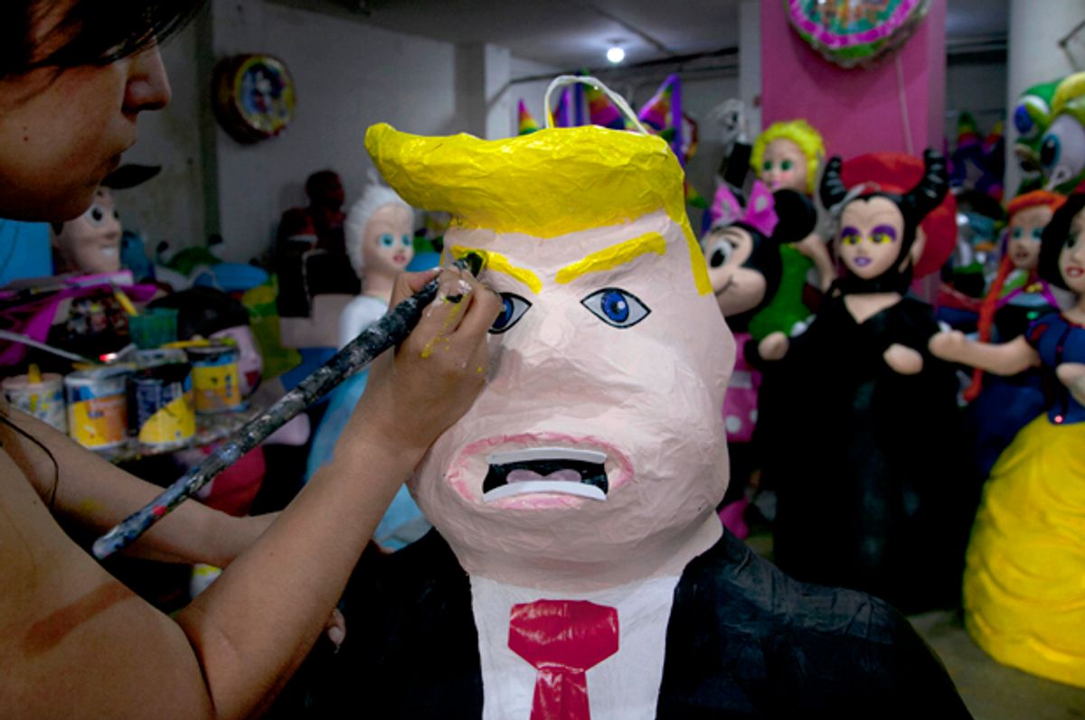 Alicia Lopez Fernandez paints a pinata depicting Donald Trump at her family's store in Mexico City, July 10, 2015.   (AP/Marco Ugarte)