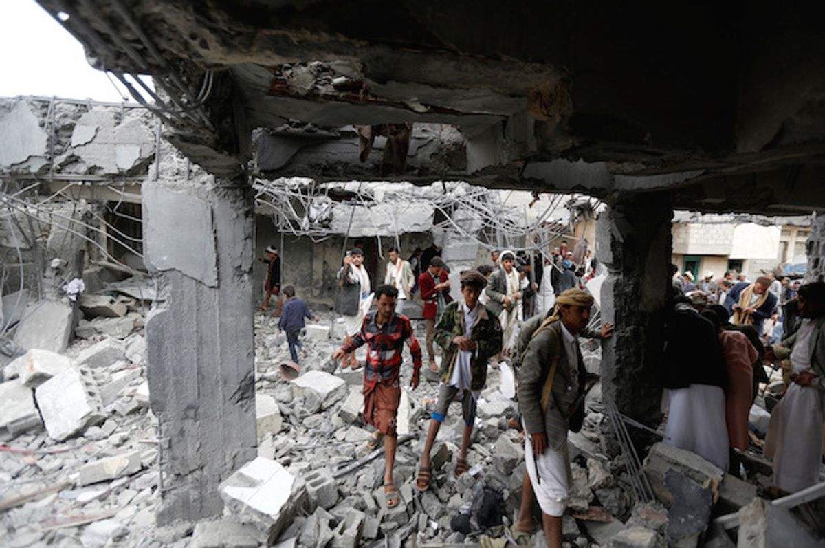 Yemenis gather at a building destroyed by Saudi-led air strikes in the northwestern city of Amran, Yemen on Sept. 8, 2016  (Reuters/Khaled Abdullah)