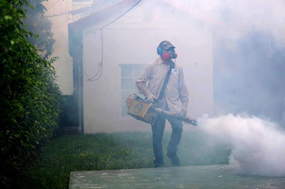 A mosquito control inspector sprays pesticide to kill mosquitos in Miami Beach, Florida, August 24, 2016.   (Getty/Joe Raedle)