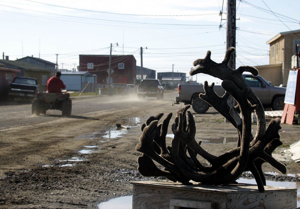 FILE - In this Aug. 12, 2005, file photo, an ATV dreives past caribou antlers on one of the dirt roads in Barrow, Alaska. Residents in Barrow, the nation's northernmost community, have voted to change the name of their city back to its traditional Inupiaq name of Utqiagvik. (AP Photo/Al Grillo, File) (AP)