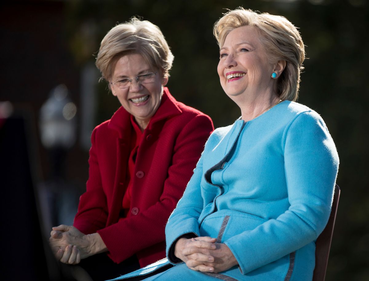 Democratic presidential candidate Hillary Clinton, accompanied by Sen. Elizabeth Warren, D-Mass., smiles as they sit on stage at a rally at St. Anselm College in Manchester, N.H., Monday, Oct. 24, 2016. (AP)