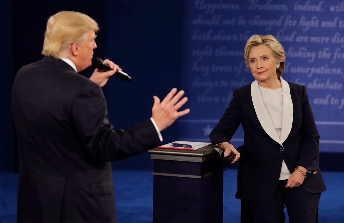 Democratic presidential nominee Hillary Clinton listens to Republican presidential nominee Donald Trump during the second presidential debate at Washington University in St. Louis, Sunday, Oct. 9, 2016. (AP Photo/John Locher) (AP)