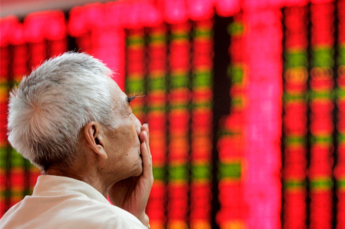 A Chinese investor looks at a stock price chart   (AP/Eugene Hoshiko)