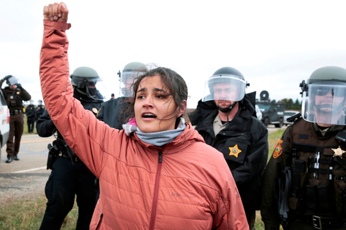 Ta'Sina Sapa Win of South Dakota's Cheyenne River Reservation chants in front of police during a protest against the Dakota Access Pipeline outside Saint Anthony, North Dakota, October 5, 2016.   (Reuters/Terray Sylvester)